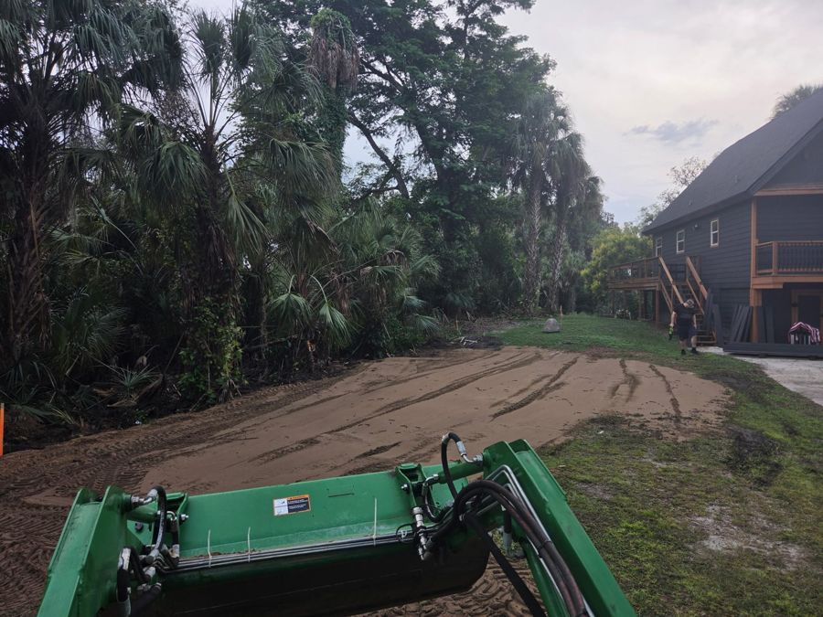 Tractor spreading fill for a house pad