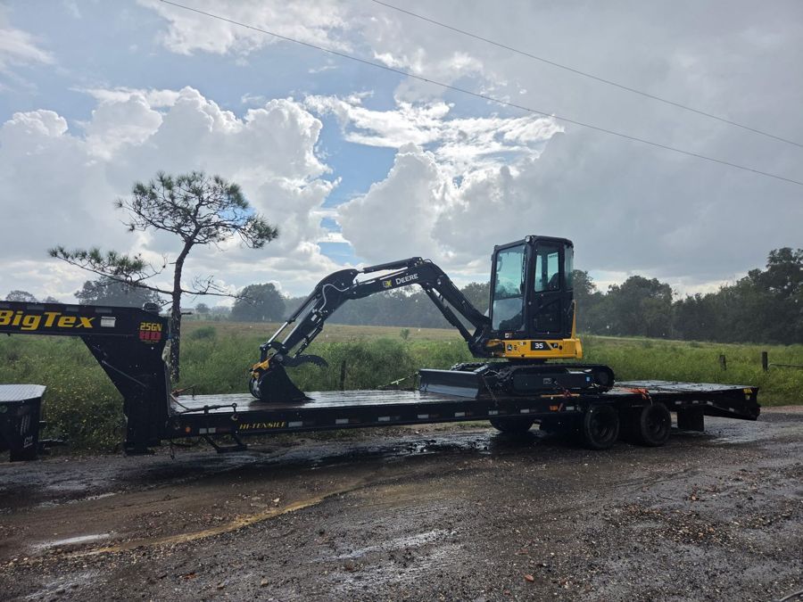 Excavator loaded on a gooseneck trailer